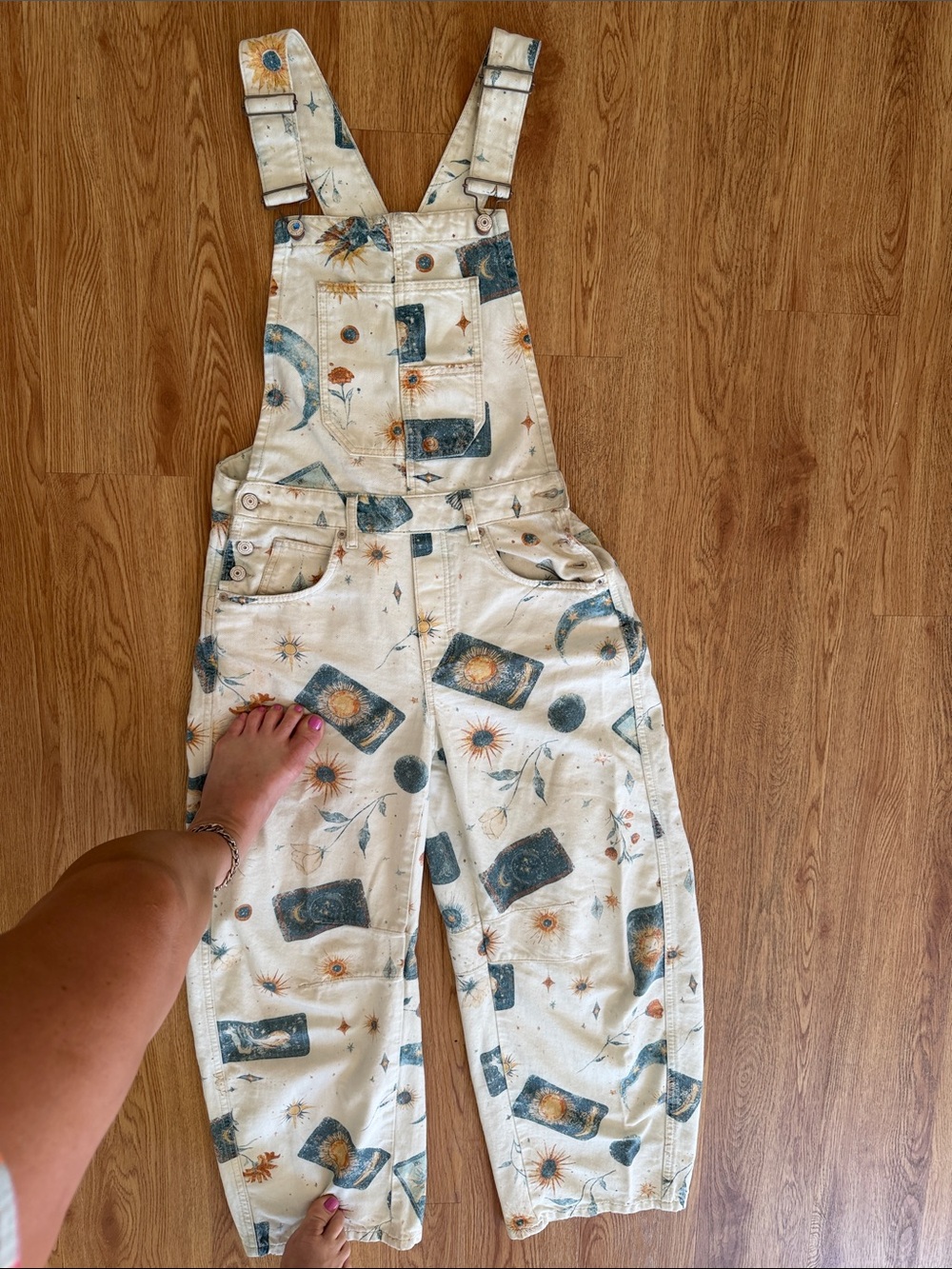 We The Free Cream Celestial Print Overalls with Blue and Orange Motifs
